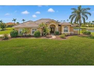 Beautiful single Gathering home with a well manicured green lawn, a brown roof, and a lake view at 6181 9Th Avenue Ne Cir, Bradenton, FL 34212
