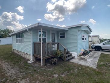 Charming home featuring a cozy porch and landscaped garden area at 1710 7Th Sw St # 24, Ruskin, FL 33570