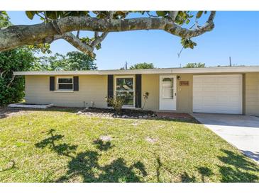 Charming single-story home with a well-manicured lawn and mature landscaping at 1764 St Croix Dr, Clearwater, FL 33759