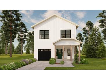 Charming two-story home features a black garage door, green front door, and lush landscaping, creating great curb appeal at 4995 16Th N Ave, St Petersburg, FL 33710