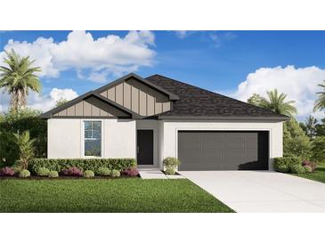 Beautiful, single-story home featuring a modern design, two-car garage, manicured lawn and tropical landscaping at 6434 Melacano Ave, Spring Hill, FL 34608