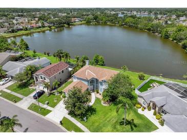Waterfront home with lush green landscaping, and beautiful lake views at 11519 Glenmont Dr, Tampa, FL 33635