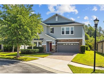 Charming two-story home boasts stone accents, a well-manicured lawn, and inviting curb appeal at 19309 Prairie Tree Pl, Tampa, FL 33647