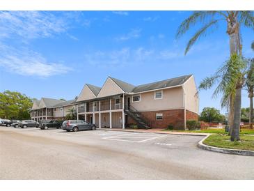 Apartment building with stairs and car park on a beautiful sunny day at 200 Country Club Dr # 308, Largo, FL 33771