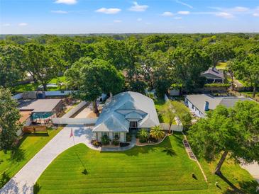 Beautiful aerial view of home with mature trees, well manicured lawn, and a charming exterior at 22304 Stillwood Dr, Land O Lakes, FL 34639