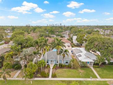 Inviting coastal home showcasing lush landscaping, a serene neighborhood, and stunning downtown skyline views at 330 47Th N Ave, St Petersburg, FL 33703