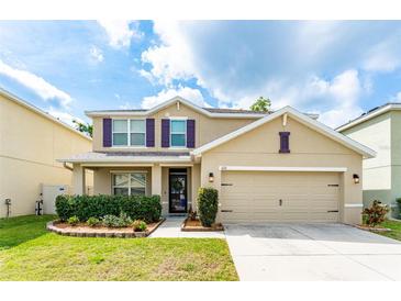 Charming two-story home featuring a well-maintained lawn, an attached two-car garage, and a classic design at 626 Diamond Ridge Rd, Seffner, FL 33584