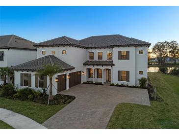 Stunning two-story home featuring a tile roof, large windows, and a spacious driveway with a two-car garage at 33736 Ocean Spray Ln, Wesley Chapel, FL 33543