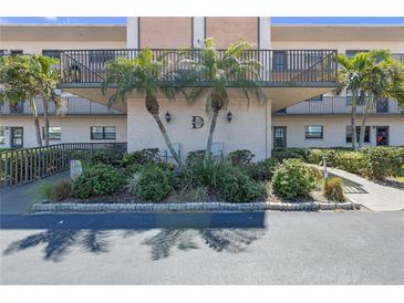 Charming condo building with palm trees, balconies, and well-maintained landscaping at 5971 Terrace Park N Dr # 307, St Petersburg, FL 33709