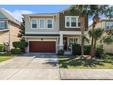 Two-story home with a two-car garage, beautifully landscaped yard, and charming front porch at 7606 S Sparkman St, Tampa, FL 33616