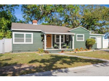 Charming single-story home features a cozy front porch, well-maintained lawn and tidy landscaping at 2125 Acorn S Pl, St Petersburg, FL 33712