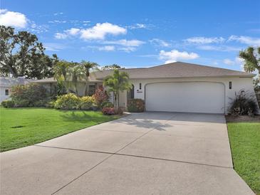 Well maintained single-story home with a wide driveway, lush landscaping and a two car garage at 3323 Ringwood Mdw, Sarasota, FL 34235