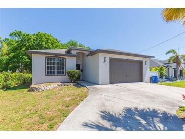 Charming single-story home with well-maintained lawn, gray trim, and a two-car garage at 6426 31St S St, St Petersburg, FL 33712
