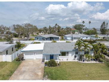 Charming single-story home with a two-car garage, well-maintained lawn, and mature landscaping at 16315 2Nd E St, Redington Beach, FL 33708