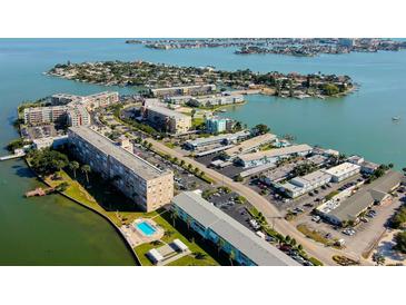 Gorgeous aerial view showcases waterfront living and building amenities including the swimming pool at 1847 Shore Drive South # 308, South Pasadena, FL 33707