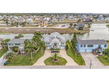 Aerial view showcases a waterfront property with extensive canals and waterway access for boating and recreation at 3432 Bluefish Dr, Hernando Beach, FL 34607