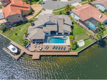 Expansive waterfront home with a private dock, pool, spa, and beautifully landscaped yard at 4803 Longwater Way, Tampa, FL 33615