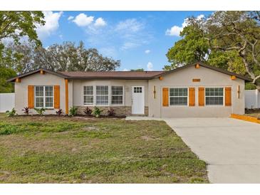 Charming single-story home with natural wood accents, complemented by a well-maintained lawn at 11347 Amboy St, Spring Hill, FL 34609