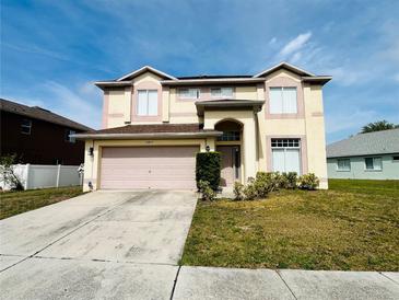 Two-story home showcasing a two-car garage and well-maintained front lawn at 12814 Longcrest Dr, Riverview, FL 33579