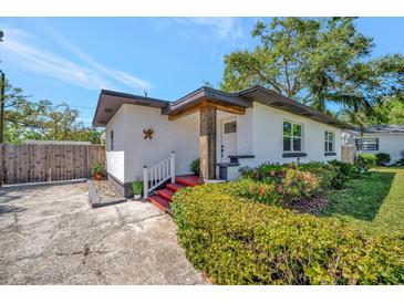 Inviting front entrance showcasing a bright exterior, neat landscaping, and a charming covered porch at 1726 25Th S Ave, St Petersburg, FL 33712