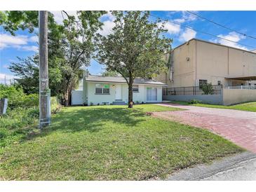 Charming home with a green lawn and a brick driveway, offering a welcoming curb appeal at 2107 E 93Rd Ave, Tampa, FL 33612