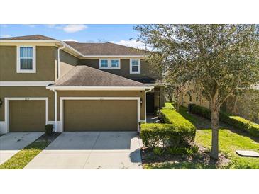 Inviting two-story townhome with lush landscaping and attached garage at 2221 Broadway View Ave, Brandon, FL 33510