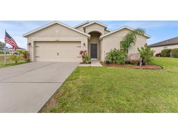 Charming single-story home with a well-manicured lawn, two car garage, and welcoming front entrance at 30475 Satinleaf Run, Brooksville, FL 34602