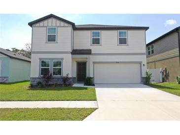 Charming two-story home with well-maintained lawn and two car garage at 35646 Eastbrook Ave, Zephyrhills, FL 33541