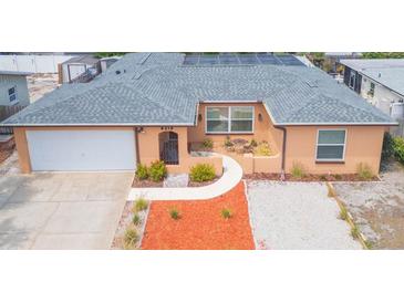 Charming single Gathering home with a well-manicured yard, solar panels, and an attached garage at 8215 Hixton Dr, Port Richey, FL 34668