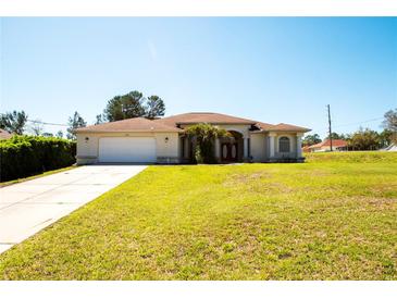 Charming single-story home featuring a spacious front yard and an attached two-car garage at 10400 Golden Ave, Weeki Wachee, FL 34613