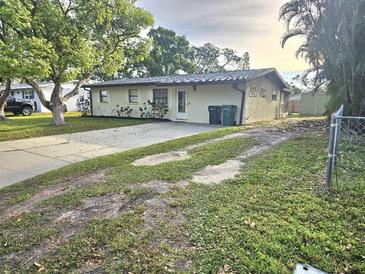 Charming single-story home featuring a well-manicured lawn and a classic driveway at 1204 23Rd W Ave, Palmetto, FL 34221