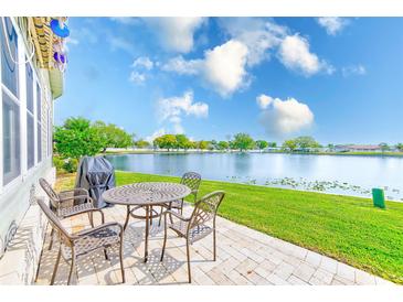 Outdoor patio features seating area with tranquil water view at 12501 Ulmerton Rd # 14, Largo, FL 33774
