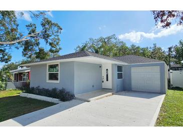 Charming single-story home featuring a well-maintained front yard and a convenient attached garage at 2712 60Th N Ave, St Petersburg, FL 33714
