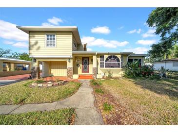 Charming two-story home with a well-maintained front yard, lovely brickwork, and inviting curb appeal at 5241 4Th S St, St Petersburg, FL 33705