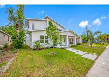 Modern two-story home with a bright white exterior, manicured lawn, and a welcoming front porch at 1030 11Th S Ave, St Petersburg, FL 33705