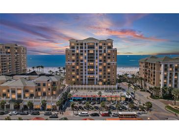 Beautiful exterior shot of this high rise beachfront condo with a view of the beach at sunset at 11 Baymont St # 1109, Clearwater Beach, FL 33767