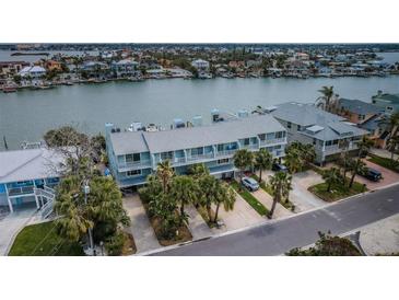 Stunning aerial view of waterfront condo with lush landscaping, parking, and serene water views at 2515 Bay Blvd # A, Indian Rocks Beach, FL 33785
