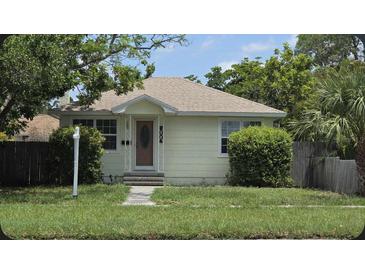 Charming single-story home featuring mature trees, a well-maintained lawn, and a welcoming front entrance at 2585 9Th N Ave, St Petersburg, FL 33713