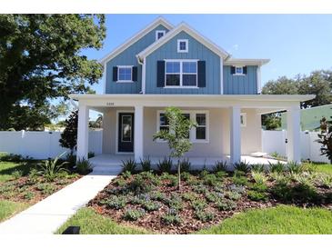 Charming two-story home with a blue exterior and a beautifully landscaped front yard at 5235 9Th N Ave, St Petersburg, FL 33710