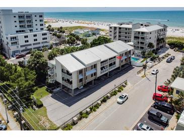 Beautiful building with balconies, a pool, and beach access offering the ultimate coastal living experience at 15 Glendale St # B6, Clearwater Beach, FL 33767