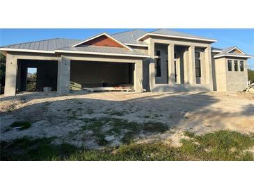 Under construction; the front exterior features a garage and a modern entrance with large windows at 440 Green Dolphin S Dr, Placida, FL 33946