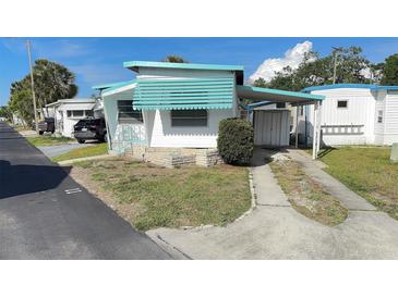 Charming single-story home featuring covered parking, front awning, and quaint landscaping at 4851 W Gandy Blvd # B2L11, Tampa, FL 33611