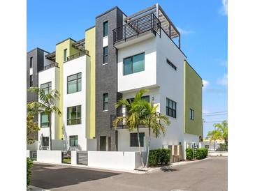 Striking modern townhomes feature a sleek design with black accents, white walls, and a private rooftop terrace at 907 Arlington N Ave, St Petersburg, FL 33705
