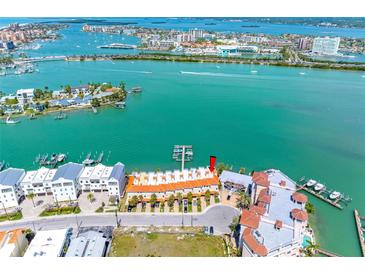 Stunning aerial view of waterfront condo complex with boat docks and beautiful turquoise water views at 200 Brightwater Dr # 10, Clearwater Beach, FL 33767
