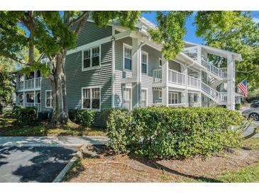 Charming condo complex with light green siding and well maintained shrubbery at 2599 Dolly Bay Dr # 209, Palm Harbor, FL 34684