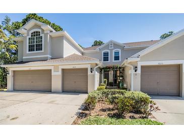 Beautiful townhome featuring a two-car garage and inviting curb appeal at 3621 Country Pointe Pl, Palm Harbor, FL 34684