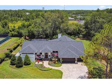 Beautiful home featuring a landscaped front yard, brick driveway, and well-maintained exterior at 506 Crystal Grove Blvd, Lutz, FL 33548