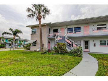 Charming two-story condo building with landscaped front yard and classic Florida palm trees at 5876 21St N St # 10, St Petersburg, FL 33714