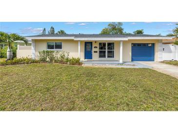 Charming single-story home with blue door and garage and freshly cut lawn at 783 41St Ne Ave, St Petersburg, FL 33703