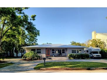 Charming single-story home with a neatly manicured lawn, inviting front porch, and a paved driveway at 3217 W Lawn Ave, Tampa, FL 33611